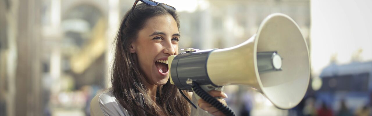 Cheerful young woman screaming the Top Hotel Marketing Myths