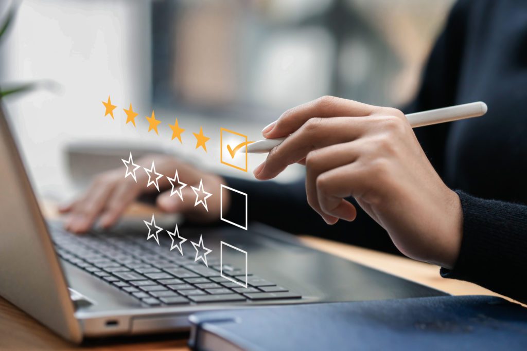 Im of businessman selecting 5-stars on digital review helping reputation management for hotels
