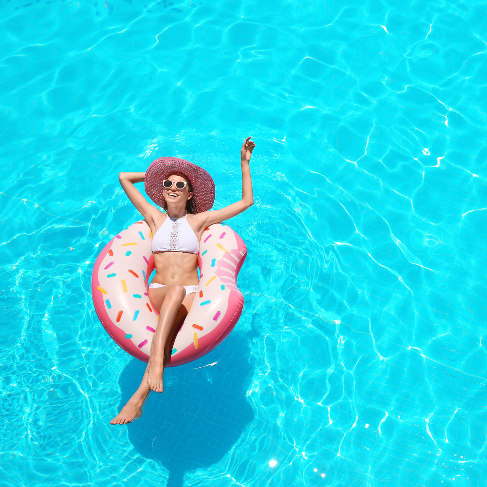 Woman floating on an inner tube in a pool.