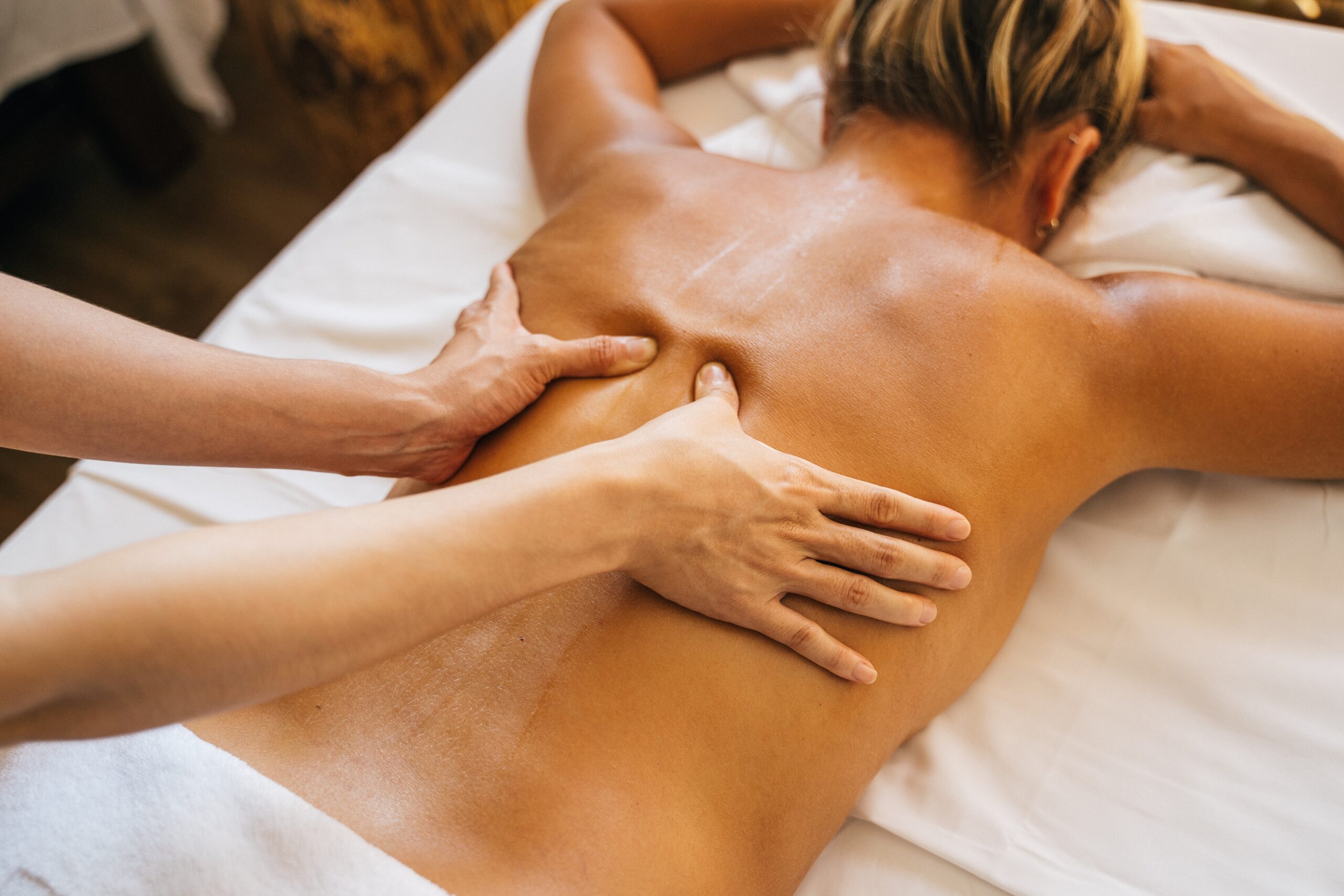 woman getting a massage at a spa on a wellness retreat